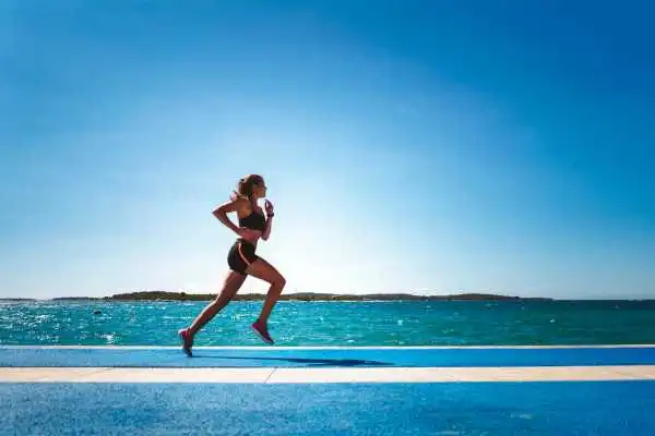 Woman running showing strong leg muscle Shefford
